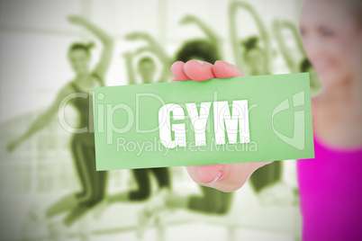 Fit blonde holding card saying gym