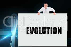 Businessman holding card saying evolution