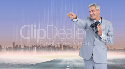 Composite image of businessman holding binoculars and pointing o Composite image of businessman holding binoculars and pointing o