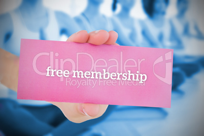 Woman holding pink card saying free membership