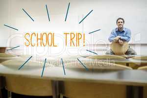 School trip against lecturer sitting in lecture hall