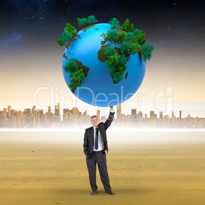 Composite image of businessman holding earth