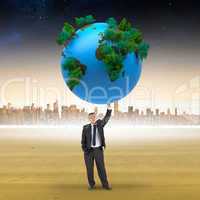 Composite image of businessman holding earth
