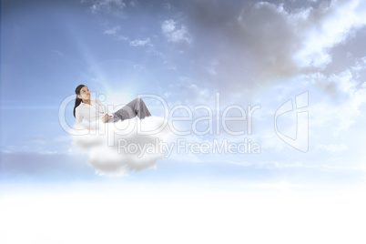 Composite image of relaxed businesswoman lying