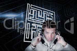Composite image of maze and businessman tangled in wires