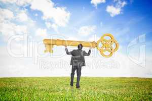 Composite image of businessman carrying large key