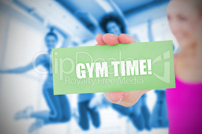 Fit blonde holding card saying gym time