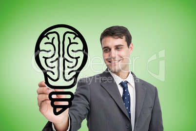 Composite image of businessman drawing light bulb