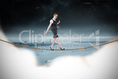 Composite image of businesswoman doing a balancing act