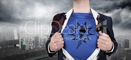 Composite image of businessman opening his shirt superhero style