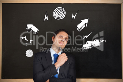 Composite image of thinking businessman holding pen