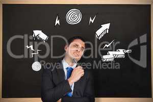 Composite image of thinking businessman holding pen