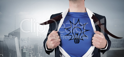 Composite image of businessman opening his shirt superhero style