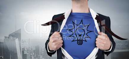 Composite image of businessman opening his shirt superhero style