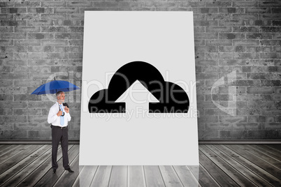 Composite image of happy businessman holding umbrella