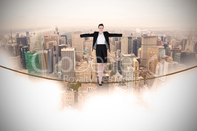 Composite image of businesswoman performing a balancing act