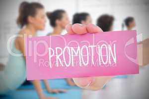 Woman holding pink card saying promotion