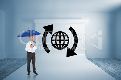 Composite image of happy businessman holding umbrella