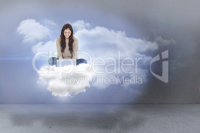 Composite image of brunette sitting on cloud using laptop