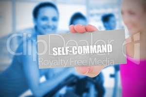 Fit blonde holding card saying self command