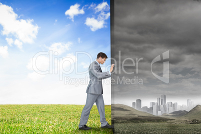 Composite image of businessman pushing away scene