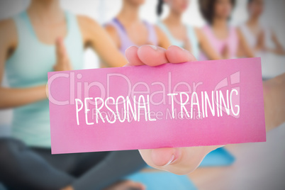 Woman holding pink card saying personal training