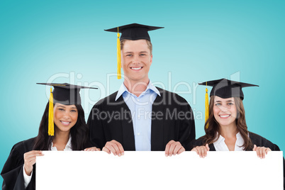 Composite image of college graduates showing card