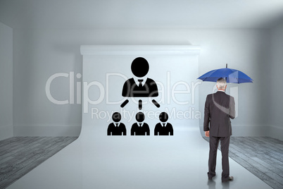 Composite image of businessman holding umbrella