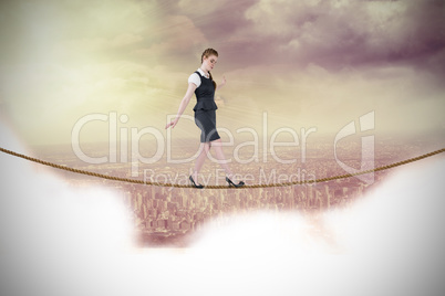 Composite image of businesswoman doing a balancing act