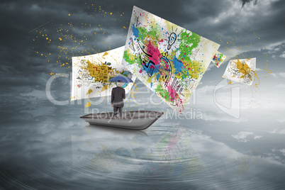 Composite image of businessman holding umbrella in a sailboat