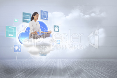 Composite image of businesswoman sitting in lotus pose