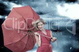 Composite image of smiling blonde holding umbrella