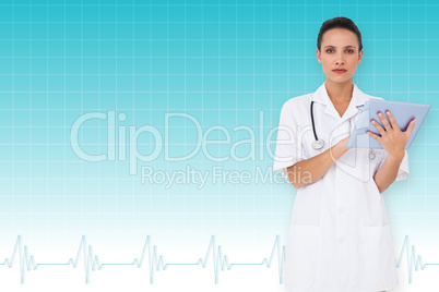 Composite image of pretty nurse using tablet pc