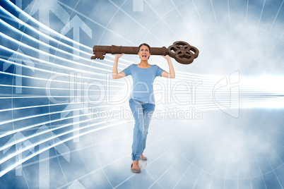 Composite image of annoyed brunette carrying large key