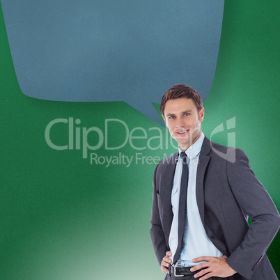 Composite image of smiling businessman with hands on hips with s