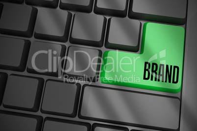 Brand on black keyboard with green key