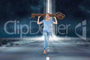 Composite image of annoyed brunette carrying large key