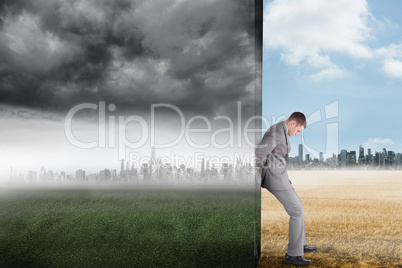 Composite image of businessman pushing away scene