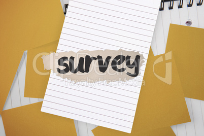 Survey against yellow paper strewn over notepad