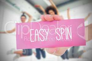 Woman holding pink card saying easy spin