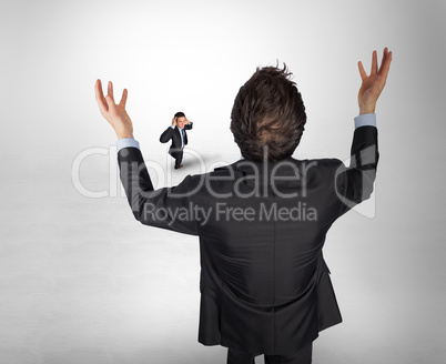 Composite image of gesturing businessman with tiny businessman