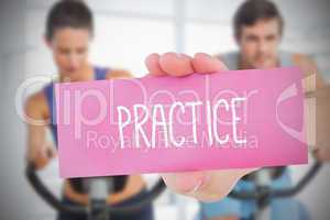 Woman holding pink card saying practice