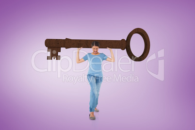 Composite image of annoyed brunette carrying large key