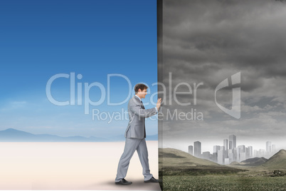 Composite image of businessman pushing away scene