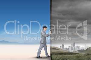 Composite image of businessman pushing away scene