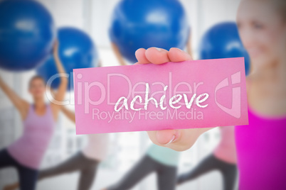 Fit blonde holding card saying achieve