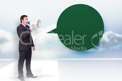 Composite image of standing businessman shouting through a megap