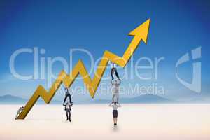 Composite image of business team holding up arrow