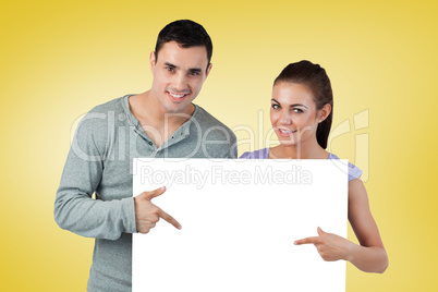 Composite image of attractive young couple showing card