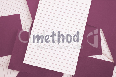 Method against purple paper strewn over notepad